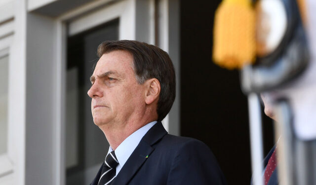 Brazilian President Jair Bolsonaro attends the changing of the guard ceremony at Planalto Palace in Brasilia, on July 31, 2019. - Bolsonaro met with US Secretary of Commerce Wilbur Ross Wednesday in Brasilia. (Photo by EVARISTO SA / AFP)