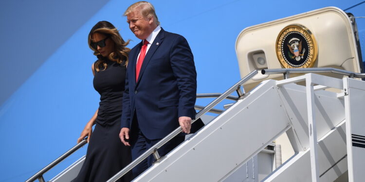 US President Donald Trump, with US First Lady Melania Trump, arrives at Wright-Patterson Air Force Base in Ohio on August 7, 2019. Trump is visiting the mass shooting sites in Dayton, Ohio, and El Paso, Texas. - Nine people were killed on August 4 in Dayton's popular Oregon District. (Photo by SAUL LOEB / AFP)