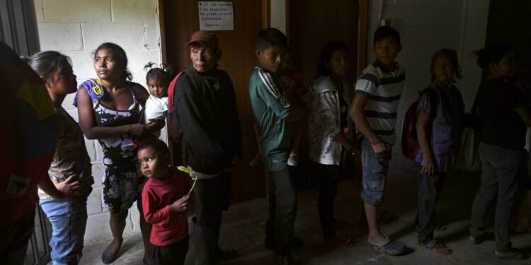 Yukpa natives wait for their turn to have a malaria test done at an improvised laboratory of Los Angeles del Tukuko mission, near Machiques, Zulia state, Venezuela on June 12, 2019. - Malaria, which had been eradicated some years ago among the Yukpa indigenous people, is back in Venezuela due to the crisis. (Photo by YURI CORTEZ / AFP)