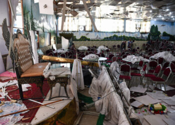 Afghan men investigate in a wedding hall after a deadly bomb blast in Kabul on August 18, 2019. - More than 60 people were killed and scores wounded in an explosion targeting a wedding in the Afghan capital, authorities said on August 18, the deadliest attack in Kabul in recent months. (Photo by Wakil KOHSAR / AFP)