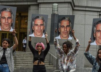 (FILES) In this file photo taken on July 8, 2019, a protest group called "Hot Mess" hold up photos of Jeffrey Epstein in front of the Federal courthouse on July 8, 2019 in New York City. - The wealthy US financier Jeffrey Epstein, indicted on charges he trafficked underage girls for sex, committed suicide in prison, US news media reported on August 10, 2019. Epstein, who had hobnobbed with politicians and celebrities over the years and was already a convicted sex offender, hanged himself in his cell at the Metropolitan Correctional Center and his body was found around 7:30 Saturday morning, The New York Times and other media said, quoting officials. (Photo by STEPHANIE KEITH / GETTY IMAGES NORTH AMERICA / AFP)