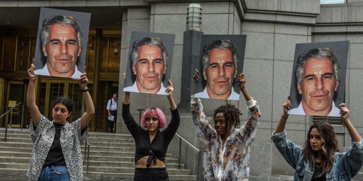 (FILES) In this file photo taken on July 8, 2019, a protest group called "Hot Mess" hold up photos of Jeffrey Epstein in front of the Federal courthouse on July 8, 2019 in New York City. - The wealthy US financier Jeffrey Epstein, indicted on charges he trafficked underage girls for sex, committed suicide in prison, US news media reported on August 10, 2019. Epstein, who had hobnobbed with politicians and celebrities over the years and was already a convicted sex offender, hanged himself in his cell at the Metropolitan Correctional Center and his body was found around 7:30 Saturday morning, The New York Times and other media said, quoting officials. (Photo by STEPHANIE KEITH / GETTY IMAGES NORTH AMERICA / AFP)