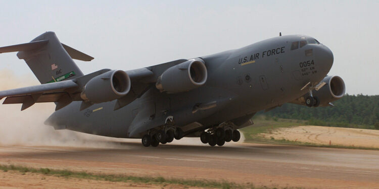 A C-17 Globemaster, 446th Airlift Wing, McChord AFB, Wa. conducts an assult landing at Holland landing zone, Ft. Bragg, N.C.  onTuesday, May 9, 2000. During Rodeo 2000, teams from all over the world will compete in areas including airdrop, aerial refueling, aircraft navigation, special tactics, short field landings, cargo loading, engine running on/offloads, aeromedical evacuations and security forces operations.  From May 6 to 13, over 80 aircraft representing more than 100 teams from 17 countries will bring in about 3,500 competitors, observers, umpires, and support people to Pope AFB, NC.  1st Combat Camera Image by Technical Sergeant James E. Lotz