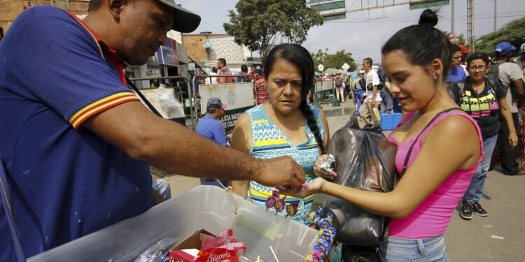 A woman buys medicines in La Parada neighborhood in Cucuta, Colombia, near the Simon Bolivar International Bridge, on the border with Tachira, Venezuela, on February 8, 2019. - Venezuelans cross to Colombia tu buy groceries due to the shortage in their country. Venezuelan President Nicolas Maduro vowed on Friday not to let in "fake" aid from the United States requested by opposition leader Juan Guaido, which is being stockpiled at the border with Colombia. (Photo by Schneyder Mendoza / AFP)