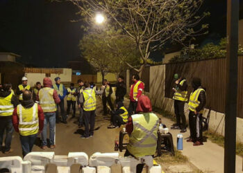 Residents of Penalolen commune hold a meeting in Santiago, Chile, on October 20, 2019, following violent protests and looting that left 11 people dead over the weekend raged on into the working week. - Neighbors across Chile allied with law enforcement to protect their homes. Dressed in yellow vests they spent the night in the street armed with shovels or pillories. (Photo by Brian SEPULVEDA / AFP)