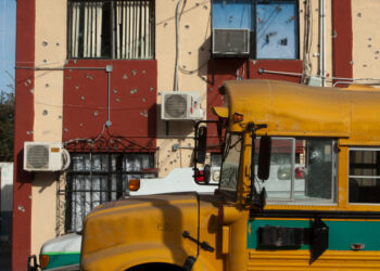 A shot school bus remains outside the Municipal Presidency in Villa Union, Coahuila state, Mexico, on December 2, 2019. - Mexican security forces were on Monday searching for the gunmen wich perpetrate the armed attack on the authorities of Villa Union over the weekend with a toll of 22 dead, including 16 of the alleged criminals. (Photo by Julio Cesar AGUILAR / AFP)