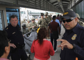 HIDALGO, TX - NOVEMBER 02: U.S. Customs and Border Protection officers and U.S. Army troops allow people to pass over the international bridge with Mexico to an immigration checkpoint on November 2, 2018 in Hidalgo, Texas. U.S. President Donald Trump ordered the troops to the border to bolster security at points where an immigrant caravan may attempt to cross in upcoming weeks.   John Moore/Getty Images/AFP