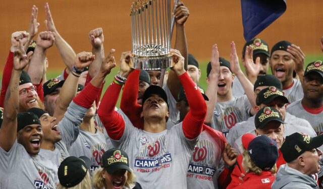 Oct 30, 2019; Houston, TX, USA; Washington Nationals left fielder Juan Soto hoists the Commissioners Trophy after defeating the Houston Astros in game seven of the 2019 World Series at Minute Maid Park. The Washington Nationals won the World Series winning four games to three. Mandatory Credit: Thomas B. Shea-USA TODAY Sports