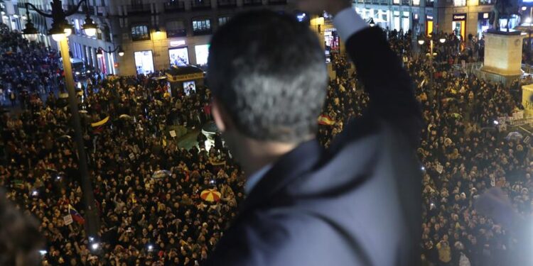 El presidente (E) de Venezuela, Juan Guaidó, saluda desde el balcón de la sede de la Comunidad de Madrid a los venezolanos concentrados en la Puerta del Sol. EFEKiko Huesca (1)