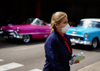 A woman wears a mask as a precaution against the spread of the new coronavirus at the Jose Marti International Airport in Havana, Cuba, Thursday, March 12, 2020, after the government announced its first new virus cases. The vast majority of people recover from the new virus. (AP Photo/Ramon Espinosa)