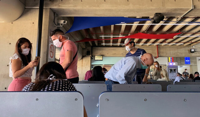 People wear protective masks in response to the spreading of coronavirus (COVID-19), at Simon Bolivar international airport in Maiquetia, Venezuela March 15, 2020. REUTERS/Carlos Jasso