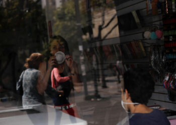 A woman wears a protective mask inside a shop in response to coronavirus (COVID-19) spread in Caracas, Venezuela March 13, 2020. REUTERS/Carlos Jasso