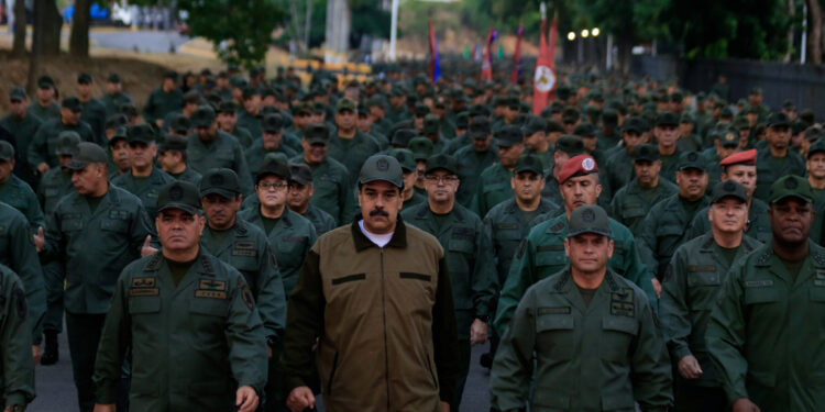 Venezuela's President Nicolas Maduro walks next to Venezuela's Defense Minister Vladimir Padrino Lopez and Remigio Ceballos, Strategic Operational Commander of the Bolivarian National Armed Forces, during a ceremony at a military base in Caracas, Venezuela May 2, 2019. (© Miraflores Palace/Handout/Reuters Pictures)