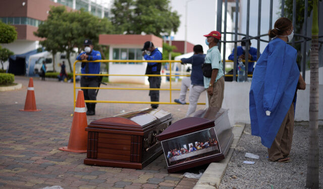 People wait next to coffins outside of Guasmo Sur General Hospital after Ecuador reported new cases of coronavirus disease (COVID-19), in Guayaquil, Ecuador April 1, 2020. REUTERS/Vicente Gaibor del Pino NO RESALES. NO ARCHIVES