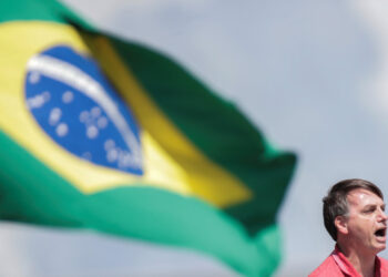 Brazil's President Jair Bolsonaro speaks after joining his supporters, who were taking part in a motorcade to protest against quarantine and social distancing measures, amid the coronavirus disease (COVID-19) outbreak, in Brasilia, Brazil April 19, 2020. REUTERS/Ueslei Marcelino