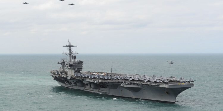 150322-N-ZF573-140 ATLANTIC OCEAN (March 22, 2015) Aircraft from Carrier Air Wing 1 fly in formation over the Nimitz-class aircraft carrier USS Theodore Roosevelt (CVN 71) during an airpower demonstration March 22, 2015. Theodore Roosevelt, homeported in Norfolk, is conducting naval operations in the U.S. 6th Fleet area of operations in support of U.S. national security interests in Europe. (U.S. Navy photo by Mass Communication Specialist 2nd Class Chris Brown/Released)