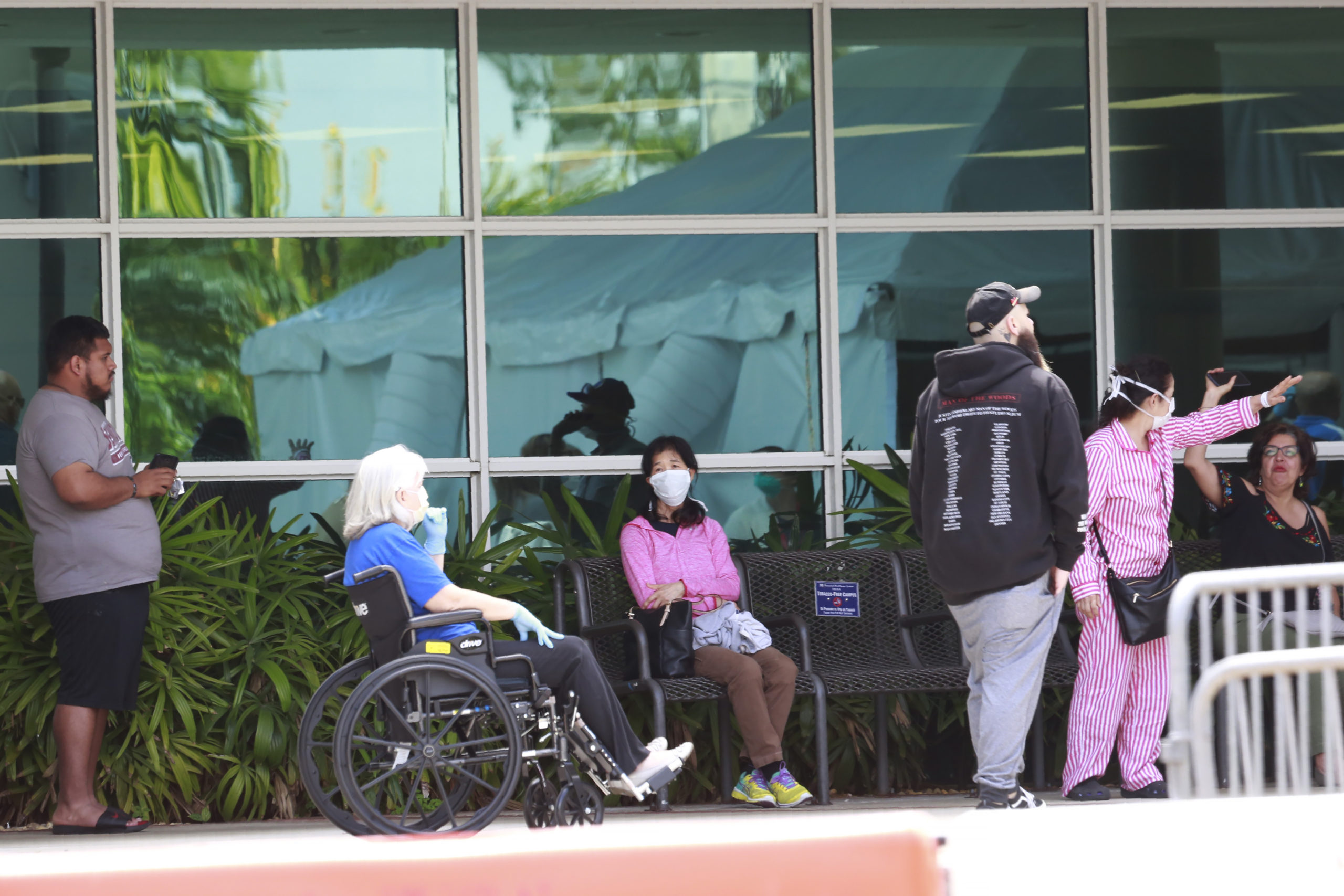 Patients wait to be seen at a medical testing site, set up amid the virus outbreak at Memorial Hospital West in Pembroke Pines, Tuesday, March 17, 2020, in Pembroke Pines, Fla. (AP Photo/Brynn Anderson)