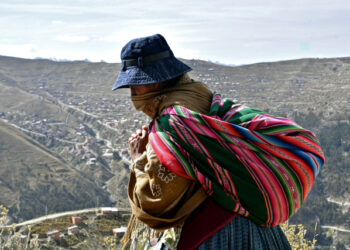 An indigenous woman walks at a low-income area in El Alto, on May 22, 2020, amid the new coronavirus pandemic. (Photo by AIZAR RALDES / AFP)