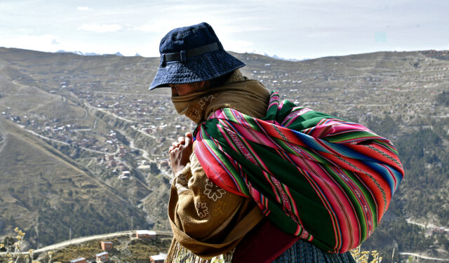 An indigenous woman walks at a low-income area in El Alto, on May 22, 2020, amid the new coronavirus pandemic. (Photo by AIZAR RALDES / AFP)