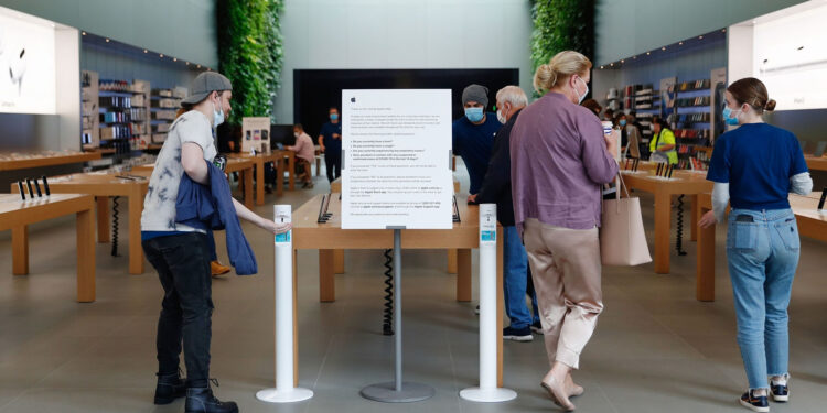 A customer uses a hand sanitizer dispenser at an Apple Inc. store reopening, after being closed due to lockdown measures imposed because of the coronavirus, in the Bondi Junction suburb of Sydney, Australia, on Thursday, May 7, 2020. Apple's app store saw its strongest month of growth in two and a half years in April, according to Morgan Stanley, which wrote that "all major regions & categories saw accelerating spend" as a result of the pandemic. Photographer: Brendon Thorne/Bloomberg