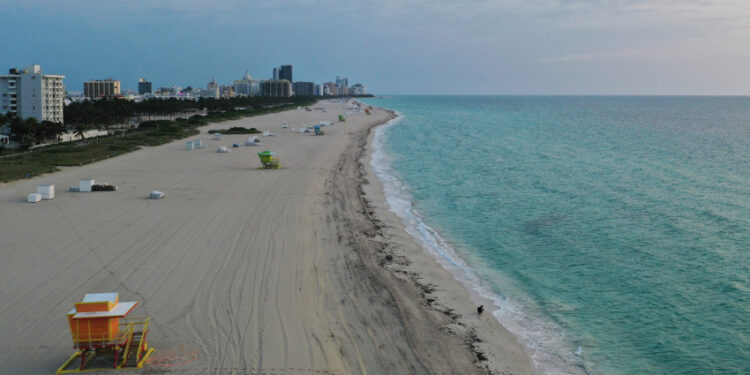 MIAMI BEACH, FLORIDA - MAY 19: An aerial drone view of the closed South Beach on May 19, 2020 in Miami Beach, Florida. The city of Miami Beach will allow "various retail stores, personal grooming establishments, offices and museums" to open staring tomorrow.  (Photo by Cliff Hawkins/Getty Images)