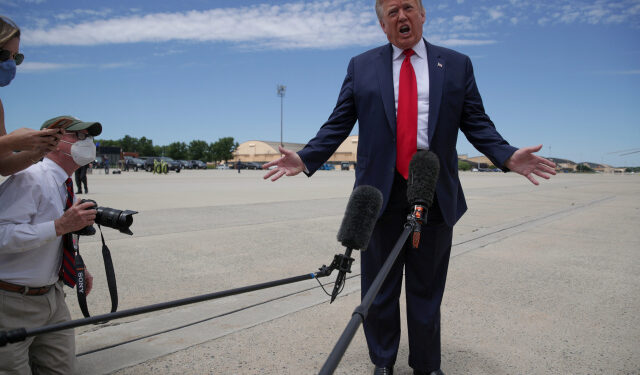 U.S. President Donald Trump shouts to be heard over the engine noise as he arrives to board Air Force One to travel to Florida to observe the launch of a SpaceX Falcon 9 rocket and Crew Dragon spacecraft, from Joint Base Andrews, Maryland, U.S. May 30, 2020. REUTERS/Jonathan Ernst