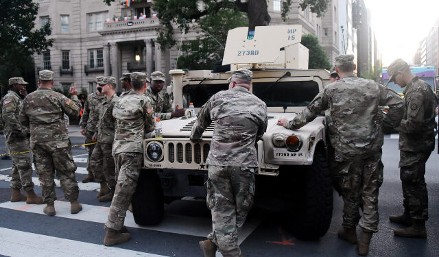 (FILES) In this file photo taken on June 7, 2020 members of the US National Guard stand near the White House as people protest against racism and police brutality in Washington, DC. - Members of the Washington DC national guard have tested positive for coronavirus in the wake of their deployment during recent protests in the US capital, the guard said on June 9, 2020. (Photo by Olivier DOULIERY / AFP)