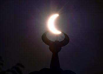 The moon partially covers the sun during an annular solar eclipse as seen from the Gulf emirate of Dubai, early on June 21, 2020. (Photo by GIUSEPPE CACACE / AFP)