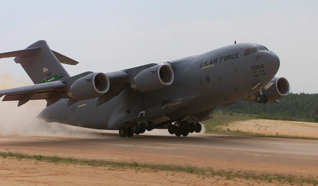 A C-17 Globemaster, 446th Airlift Wing, McChord AFB, Wa. conducts an assult landing at Holland landing zone, Ft. Bragg, N.C.  onTuesday, May 9, 2000. During Rodeo 2000, teams from all over the world will compete in areas including airdrop, aerial refueling, aircraft navigation, special tactics, short field landings, cargo loading, engine running on/offloads, aeromedical evacuations and security forces operations.  From May 6 to 13, over 80 aircraft representing more than 100 teams from 17 countries will bring in about 3,500 competitors, observers, umpires, and support people to Pope AFB, NC.  1st Combat Camera Image by Technical Sergeant James E. Lotz