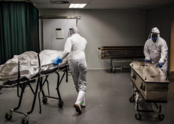 Undertakers move remains of COVID-19 coronavirus patients at the AVBOB funeral house in Soweto, on July 21, 2020. (Photo by MARCO LONGARI / AFP)