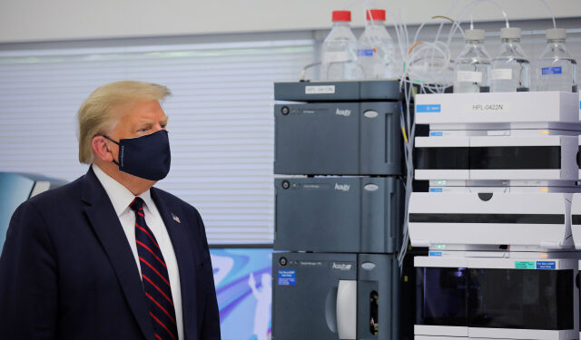 U.S. President Donald Trump wears a protective face mask during a tour of the Fujifilm Diosynth Biotechnologies' Innovation Center, a pharmaceutical manufacturing plant where components for a potential coronavirus disease  (COVID-19) vaccine candidate are being developed, in Morrrisville, North Carolina, U.S., July 27, 2020. REUTERS/Carlos Barria