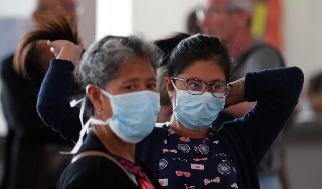 Travelers wear masks at the El Dorado airport in Bogota, Colombia, 17 March 2020. Colombian authorities confirmed eight new cases of coronavirus on Tuesday, bringing the number to 65 across the country, which restricted flights, closed land and sea borders to deal with the pandemic. EFE/ Mauricio Duenas Castaneda