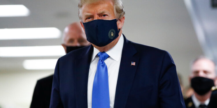 President Donald Trump wears a mask as he walks down the hallway during his visit to Walter Reed National Military Medical Center in Bethesda, Md., Saturday, July 11, 2020. (AP Photo/Patrick Semansky)