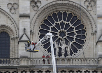 Firefighters secure Notre-Dame Cathedral in Paris on April 16, 2019, in the aftermath of a fire that caused its spire to crash to the ground. - Crowds of stunned Parisians and tourists -- some crying, others offering prayers -- watched in horror in central Paris on April 15 night as firefighters struggled for hours to extinguish the flames engulfing the Notre-Dame Cathedral. (Photo by Thomas SAMSON / AFP)