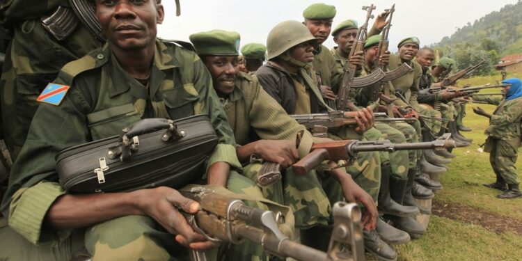 Government troops ride on a vehicle towards the frontline where they are fighting M23 rebels outside the eastern Congolese city of Goma, July 25, 2012. Congolese rebels and government forces traded heavy weapons fire around two eastern villages on Friday, forcing thousands of civilians to flee towards the provincial capital days ahead of a regional summit due to tackle the rebellion. REUTERS/James Akena (DEMOCRATIC REPUBLIC OF CONGO - Tags: CIVIL UNREST POLITICS CONFLICT)