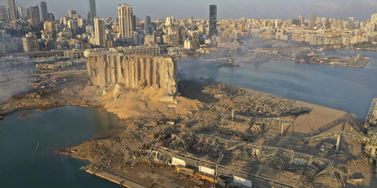 A drone picture shows the scene of an explosion that hit the seaport of Beirut, Lebanon, Wednesday, Aug. 5, 2020. A massive explosion rocked Beirut on Tuesday, flattening much of the city's port, damaging buildings across the capital and sending a giant mushroom cloud into the sky. (AP Photo/Hussein Malla)