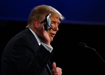 US President Donald Trump holds a face mask as he speaks during the first presidential debate at the Case Western Reserve University and Cleveland Clinic in Cleveland, Ohio on September 29, 2020. (Photo by JIM WATSON / AFP) (Photo by JIM WATSON/AFP via Getty Images)