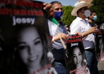 People hold placards as they attend a protest against the decision of the Mexican government to divert water from La Boquilla dam to the U.S., as part of a 1944 bilateral water treaty between the two countries, in Delicias, Chihuahua state, Mexico September 20, 2020. REUTERS/Jose Luis Gonzalez