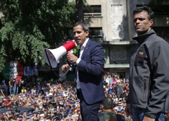 Venezuelan opposition leader and self-proclaimed acting president Juan Guaido (C) speaks to supporters next to high-profile opposition politician Leopoldo Lopez, who had been put under home arrest by Venezuelan President Nicolas Maduro's regime, and members of the Bolivarian National Guard who joined his campaign to oust Maduro, in Caracas on April 30, 2019. - Guaido -- accused by the government of attempting a coup Tuesday -- said there was "no turning back" in his attempt to oust President Nicolas Maduro from power. (Photo by Cristian HERNANDEZ / AFP)        (Photo credit should read CRISTIAN HERNANDEZ/AFP/Getty Images)