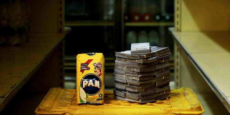 A package of 1kg of corn flour is pictured next to 2,500,000 bolivars, its price and the equivalent of 0.38 USD, at a mini-market in Caracas, Venezuela August 16, 2018. It was the going price at an informal market in the low-income neighborhood of Catia. REUTERS/Carlos Garcia Rawlins   SEARCH "GARCIA ECONOMY" FOR THIS STORY. SEARCH "WIDER IMAGE" FOR ALL STORIES.