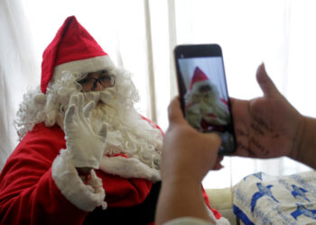 Alberto Molina poses for a picture dressed up as Santa Claus, before giving away toys to children in poverty, motivated by the death of his grandson from leukemia 8 years ago, at his home in Monterrey, Mexico December 22, 2020. Picture taken December 22, 2020. REUTERS/Daniel Becerril