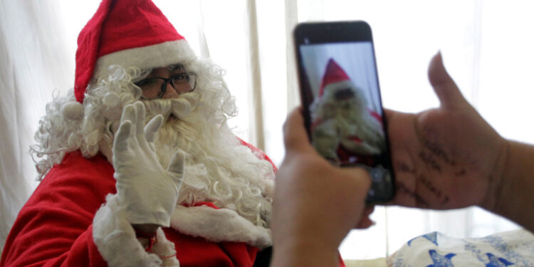 Alberto Molina poses for a picture dressed up as Santa Claus, before giving away toys to children in poverty, motivated by the death of his grandson from leukemia 8 years ago, at his home in Monterrey, Mexico December 22, 2020. Picture taken December 22, 2020. REUTERS/Daniel Becerril