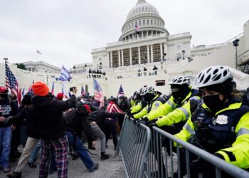 Trump supporters try to break through a police barrier, Wednesday, Jan. 6, 2021, at the Capitol in Washington. As Congress prepares to affirm President-elect Joe Biden's victory, thousands of people have gathered to show their support for President Donald Trump and his claims of election fraud. (AP Photo/John Minchillo)