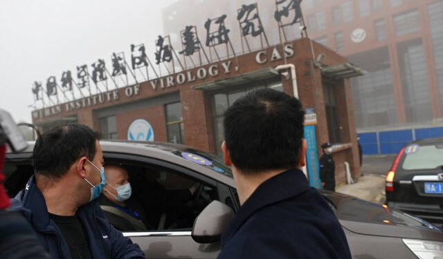 Members of the World Health Organization (WHO) team investigating the origins of the COVID-19 coronavirus arrive by car at the Wuhan Institute of Virology in Wuhan in China's central Hubei province on February 3, 2021. (Photo by HECTOR RETAMAL / AFP)