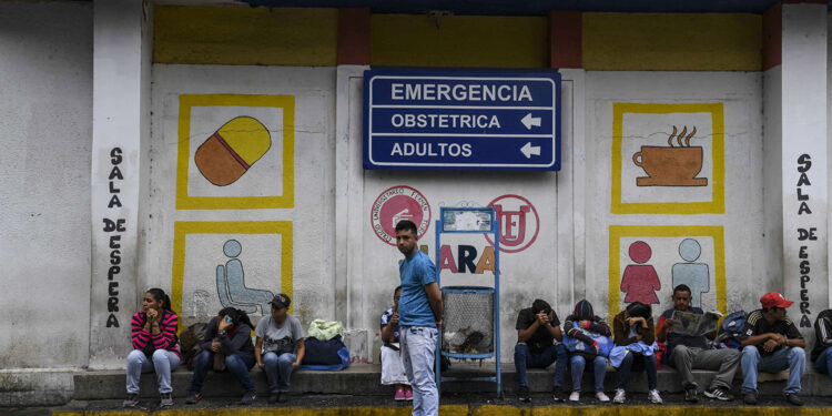 Relatives of patients that are been treated at the University Hospital wait in front of the building in Barquisimeto, Venezuela on April 24, 2019. - Venezuela is facing the worst crisis in its modern history with inflation expecting to soar a mind-boggling 10 million percent this year, contributing to a shortage of basic goods that has caused more than 2.7 million people to flee since 2015, according to the United Nations. (Photo by YURI CORTEZ / AFP)        (Photo credit should read YURI CORTEZ/AFP via Getty Images)