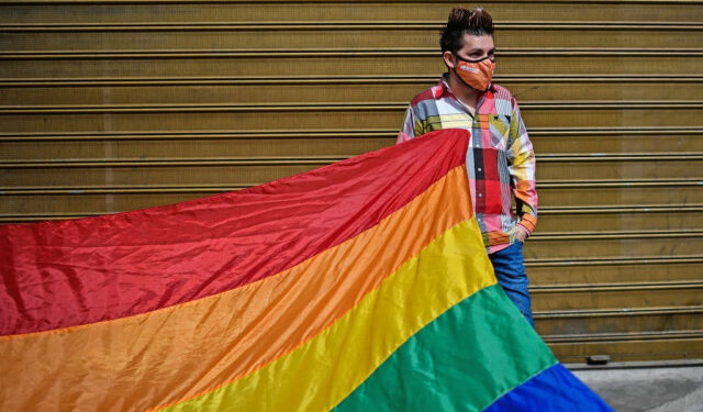 (FILES) In this file photo taken on February 11, 2021 a member of the Venezuelan LGBTI (lesbian, gay, bi-sexual, transsexual and intersex) community takes part in a demonstration demanding marriage equality, in front of the National Assembly building in Caracas. - LGBTI organizations in Venezuela, which is behind in the line of Latin American countries in terms of rights of the LGBTI community, are pushing for the new Parliament to discuss an equal marriage law in 2021. (Photo by Federico PARRA / AFP)