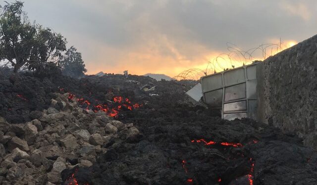 Smoldering ashes are seen early morning in Goma in the East of the Democratic Republic of Congo on May 23, 2021 following the eruption of Mount Nyiragongo. - Thousands have fled a volcanic eruption in the Democratic Republic of Congo with lava from Mount Nyiragongo reaching Goma city early Sunday. Even before the official announcement, people had started filling the streets and carrying what they could as they headed out of the city, where the last major eruption killed 100 people. (Photo by Moses Sawasawa / AFP)