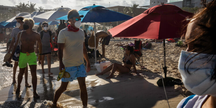 Playa del Carmen, Quintana Roo, Mexico November 22, 2020 Tourists on the beach. Photo by Claudia Guadarrama  From Outside of Paradise series, chapter COVID-19 impact. An ongoing documentary project on economic and social order and its effects on the residents of one of the most visited tourist cities in the world. “Produced with support from the Magnum Foundation.”