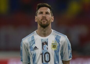 Argentina's Lionel Messi listens to the anthem as he wears the jersey of the national team bearing a picture of late Argentine football star Diego Armando Maradona before the start of the South American qualification football match for the FIFA World Cup Qatar 2022 against Chile at the Estadio Unico Madre de Ciudades stadium in Santiago del Estero, Argentina, on June 3, 2021. (Photo by Juan Mabromata / POOL / AFP)
