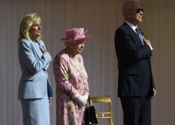 Britain's Queen Elizabeth II stands with US President Joe Biden and First Lady Jill Biden as they listen to the US national anthem at Windsor Castle near London, Sunday, June 13, 2021. (AP Photo/Alberto Pezzali)